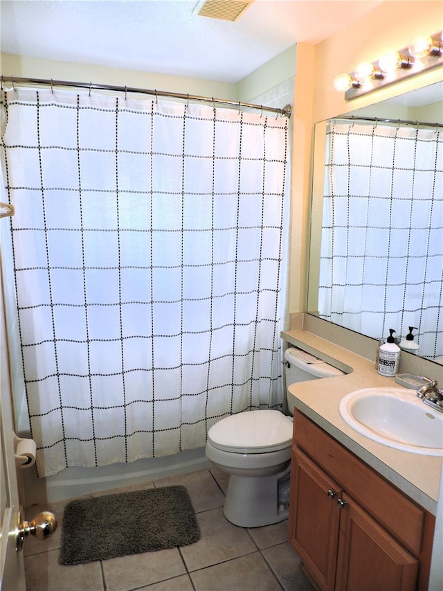 bathroom featuring toilet, shower / bath combo, tile patterned flooring, and vanity