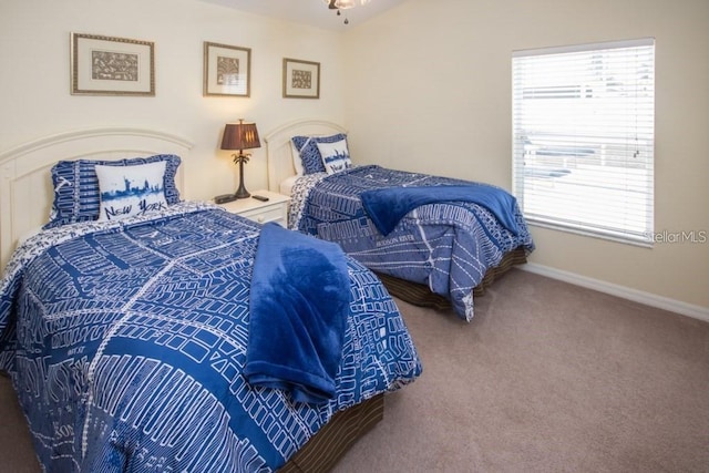 bedroom with carpet floors and baseboards