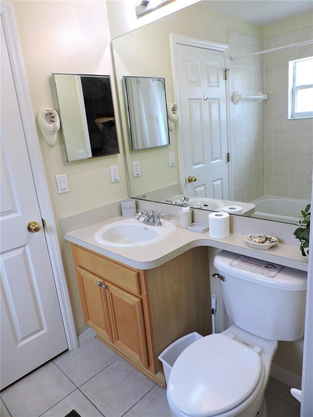 bathroom featuring shower / bath combination, vanity, toilet, and tile patterned floors