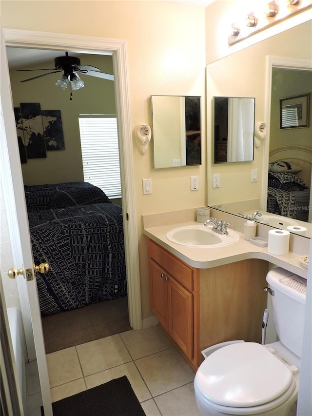 bathroom with toilet, ceiling fan, vanity, ensuite bath, and tile patterned floors