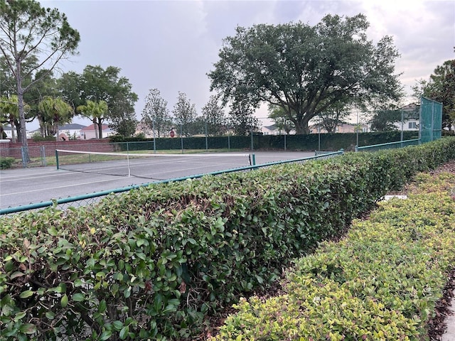 view of tennis court featuring fence