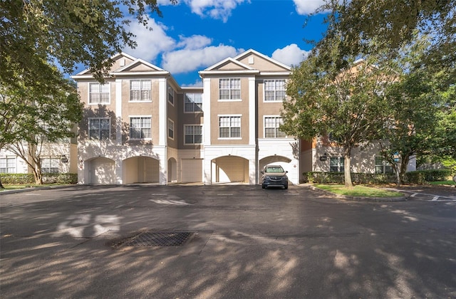 multi unit property featuring a garage