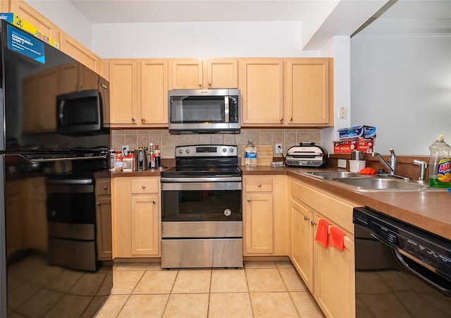 kitchen with light brown cabinets, sink, ornamental molding, light tile patterned flooring, and stainless steel appliances