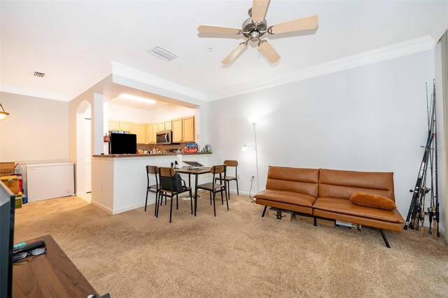 living room with light carpet, ceiling fan, and crown molding