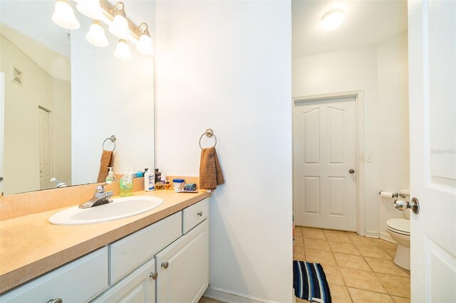 bathroom featuring tile patterned floors, vanity, and toilet