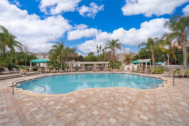 view of pool with a patio and a pergola