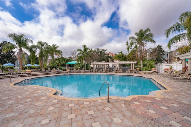 view of swimming pool featuring a patio and a pergola