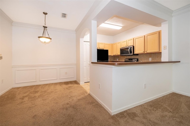 kitchen featuring pendant lighting, fridge, kitchen peninsula, and light carpet