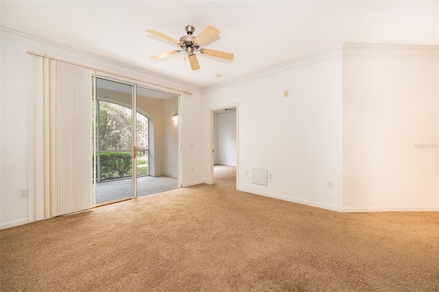 carpeted empty room featuring crown molding and ceiling fan