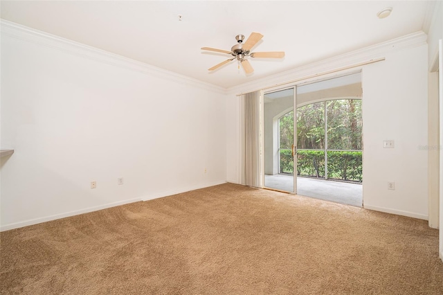 spare room featuring crown molding, carpet floors, and ceiling fan