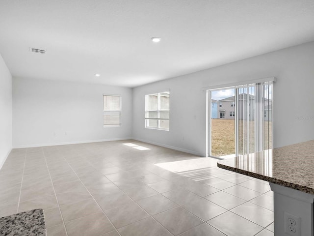 unfurnished living room with light tile patterned flooring