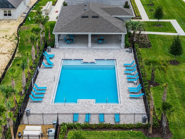 view of pool with a lawn and a patio area