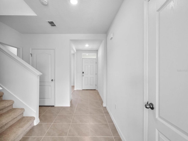 hall with light tile patterned flooring