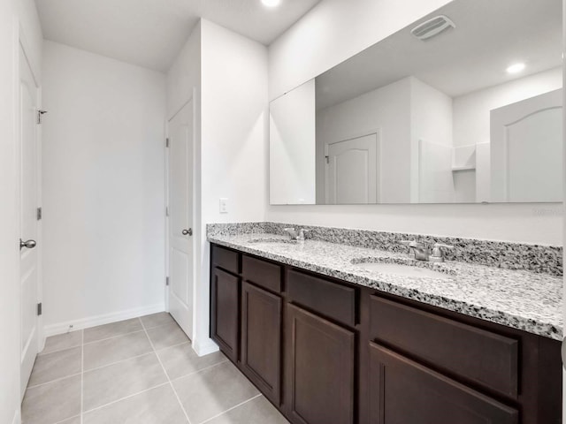 bathroom with tile patterned floors and double vanity