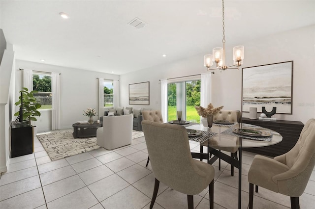 tiled dining room with a notable chandelier