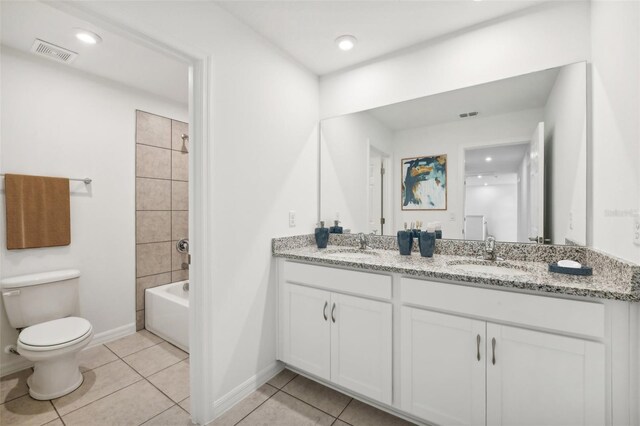 full bathroom featuring shower / bathing tub combination, toilet, dual bowl vanity, and tile patterned flooring