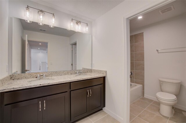 full bathroom with tile patterned floors, double vanity, shower / bathtub combination, and toilet