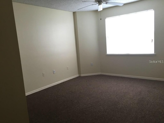 unfurnished room with ceiling fan, a textured ceiling, and carpet floors