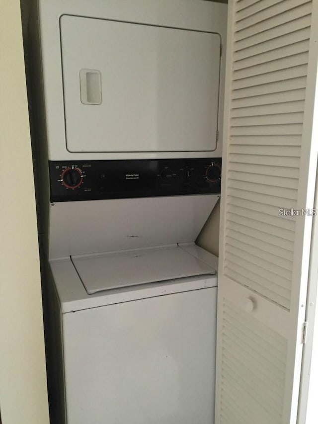 laundry area featuring stacked washer / dryer