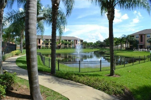 view of community with a yard and a water view