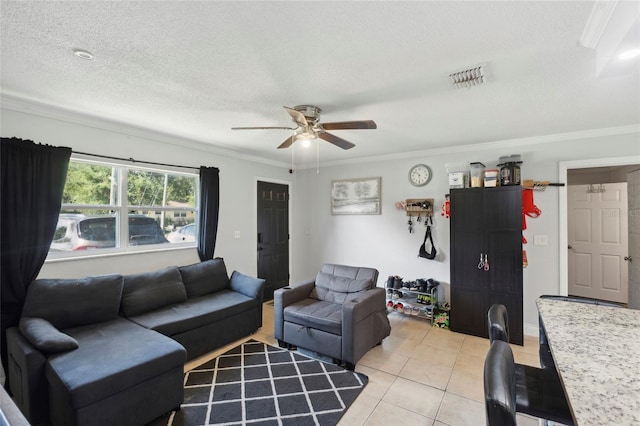 tiled living room with ceiling fan, crown molding, and a textured ceiling