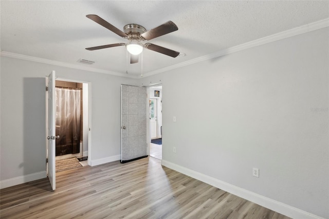 unfurnished bedroom with ceiling fan, crown molding, and light wood-type flooring