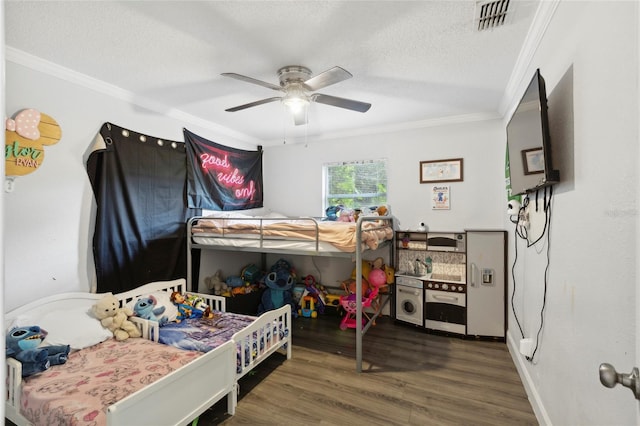 bedroom featuring ceiling fan, hardwood / wood-style flooring, crown molding, and a textured ceiling