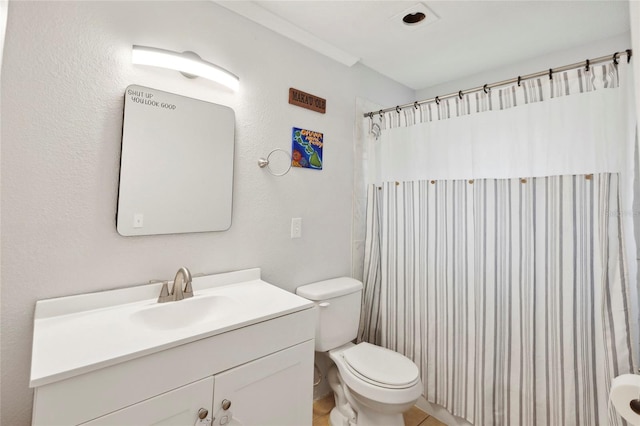 bathroom with toilet, vanity, a shower with curtain, and tile patterned floors