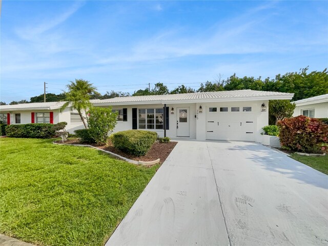 ranch-style home with a front lawn and a garage