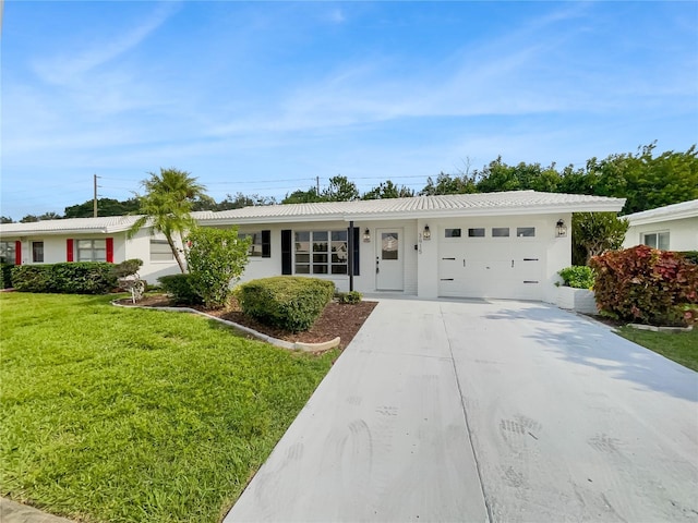 ranch-style house with driveway, a garage, a front lawn, and stucco siding