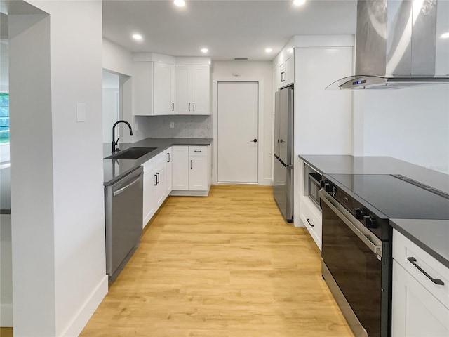 kitchen featuring stainless steel appliances, range hood, a sink, and dark countertops