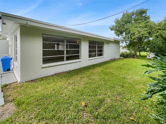 view of home's exterior with a yard and stucco siding