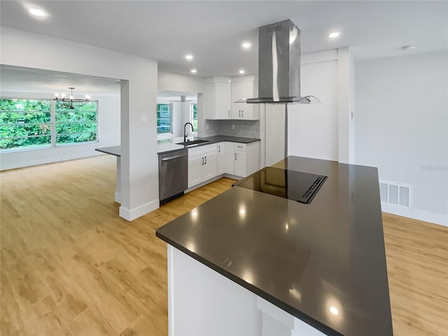 kitchen with stainless steel dishwasher, dark countertops, island exhaust hood, and white cabinets