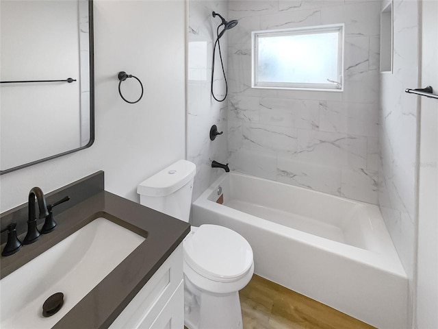 bathroom with toilet, tub / shower combination, wood finished floors, and vanity