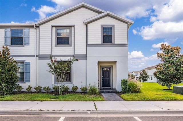 view of front of property with a front lawn and stucco siding