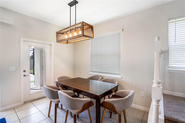 dining space with light tile patterned floors and baseboards