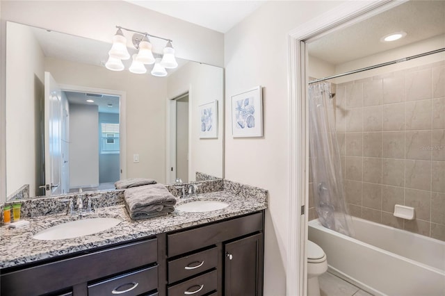 full bath with double vanity, shower / bathtub combination with curtain, toilet, and a sink