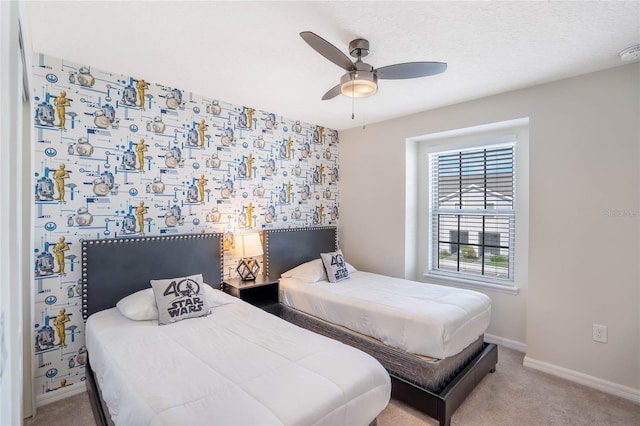 bedroom featuring a ceiling fan, light carpet, and baseboards