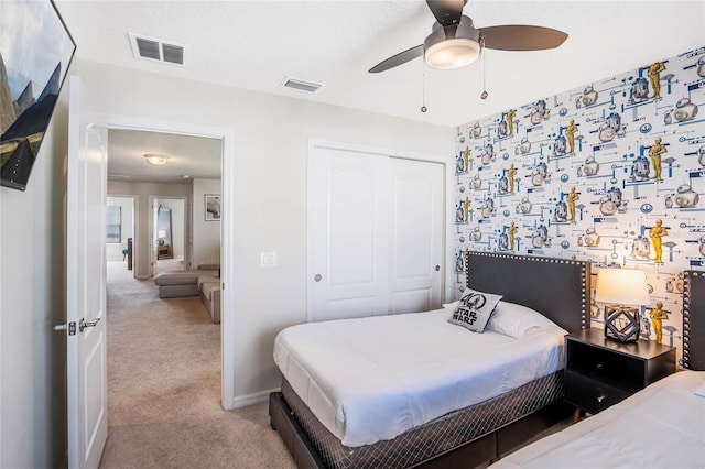 bedroom with light carpet, a closet, visible vents, and baseboards