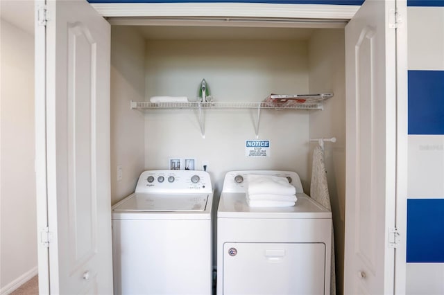 clothes washing area featuring washer and dryer and laundry area