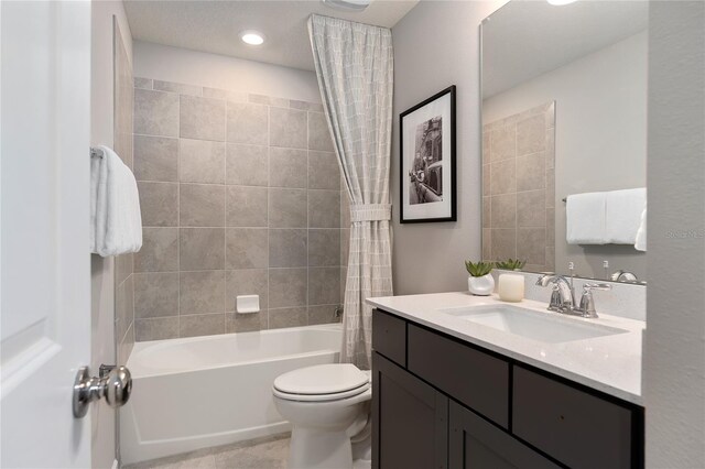 full bathroom featuring shower / bath combination with curtain, vanity, and toilet