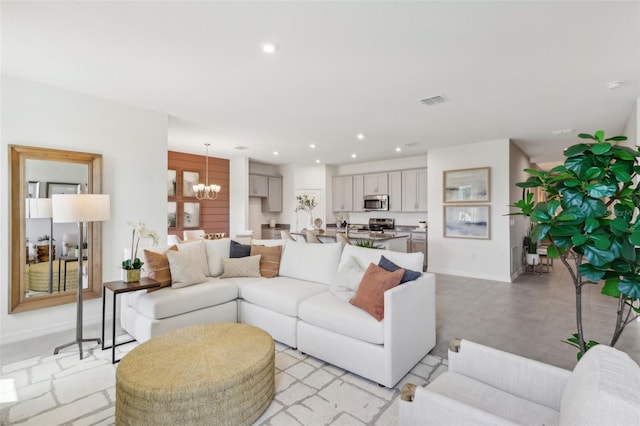 tiled living room featuring an inviting chandelier