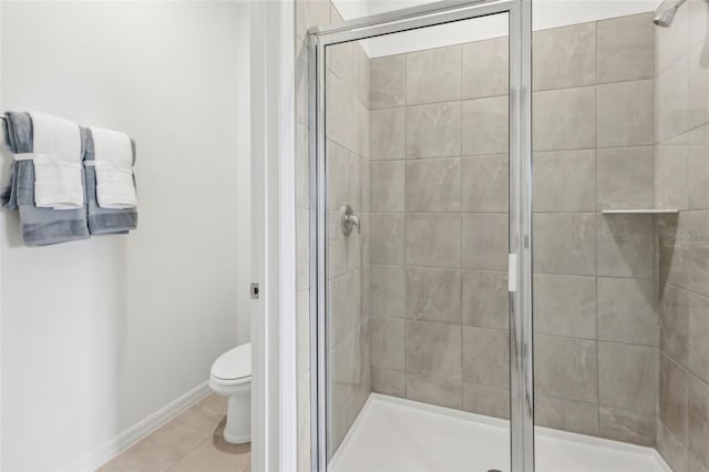 bathroom with toilet, a shower with door, and tile patterned floors