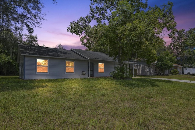 ranch-style house with a lawn