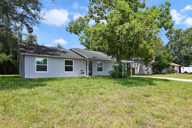 ranch-style home featuring a front yard