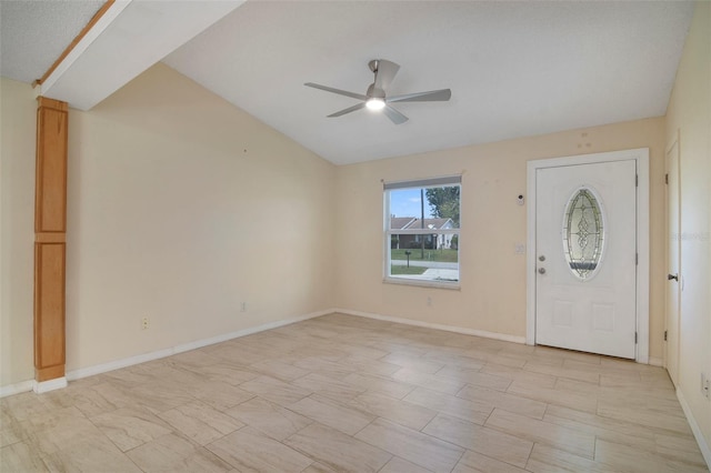 tiled foyer with ceiling fan and vaulted ceiling