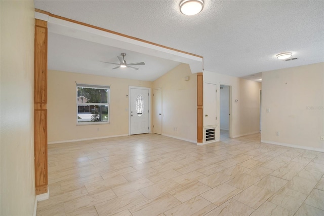 interior space featuring a textured ceiling, ceiling fan, and lofted ceiling