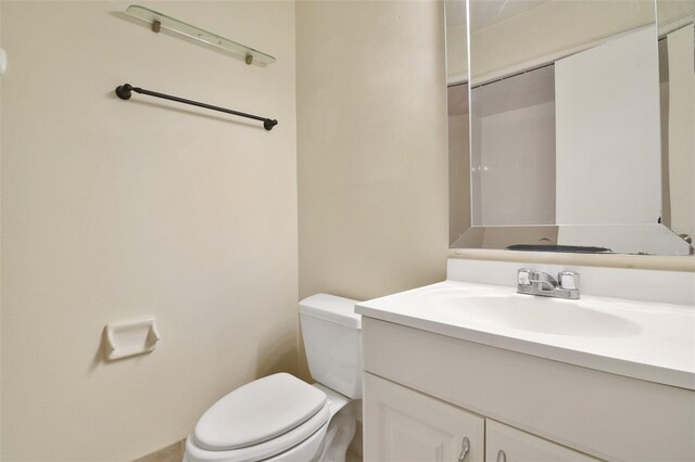 bathroom featuring toilet and vanity