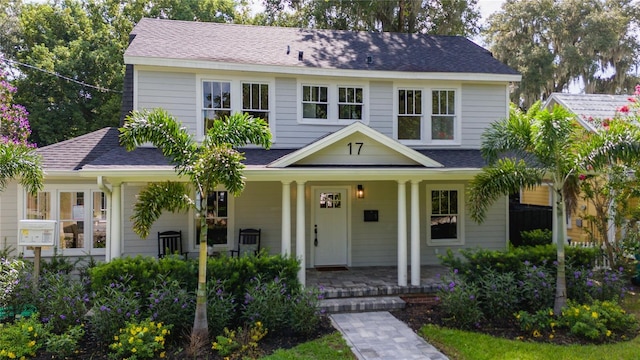 view of front of property with a porch and roof with shingles