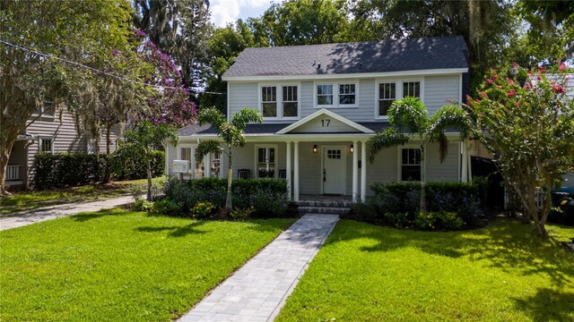 view of front of property featuring a front yard and a porch